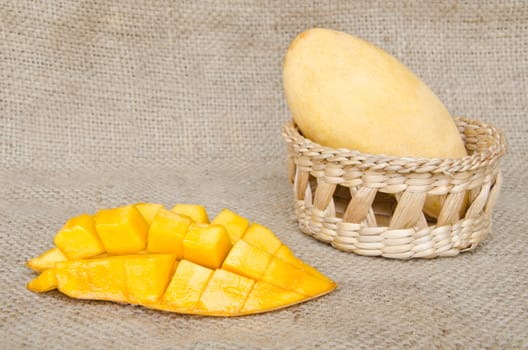 Ripe mangos on sack background