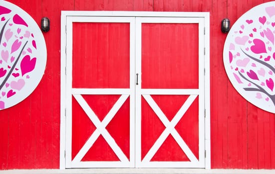 Wooden door on a red background, and decorations.