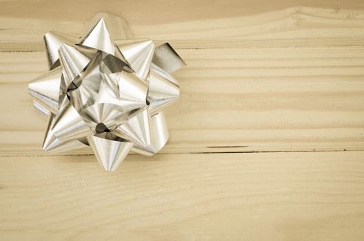 silver ribbon on wooden background vintage style.