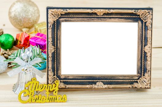 Vintage blank photo frame with christmas decorations on wood background. Save clipping path.