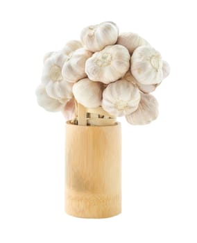 Fresh garlic in wooden cup on white background.