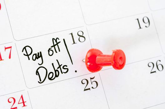 The words Pay off Debts written on a Calendar
