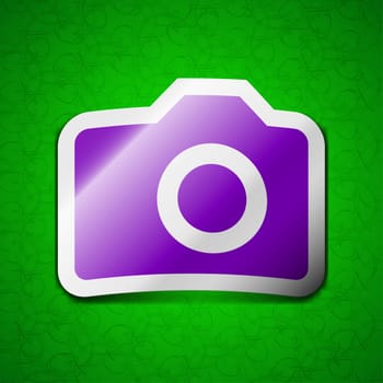 Digital photo camera icon sign. Symbol chic colored sticky label on green background. illustration