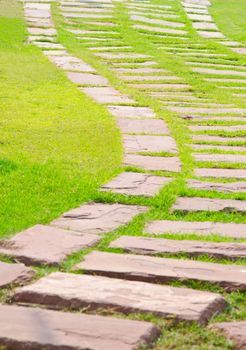 stone walkway on green in park.