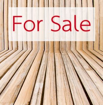 Sale tag on wooden background.