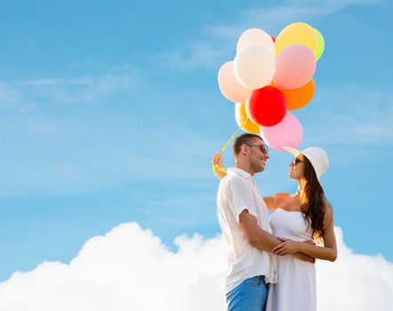 love, wedding, summer, dating and people concept - smiling couple wearing sunglasses with balloons hugging over blue sky and cloud background