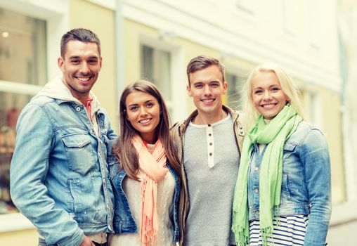 travel, vacation and friendship concept - group of smiling friends in city