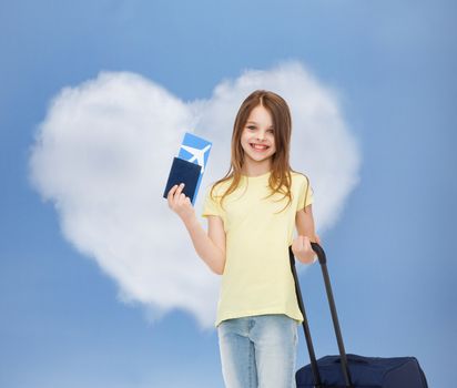 tourism, vacation, childhood and transportation concept - smiling little girl with travel bag, ticket and passport over airport background