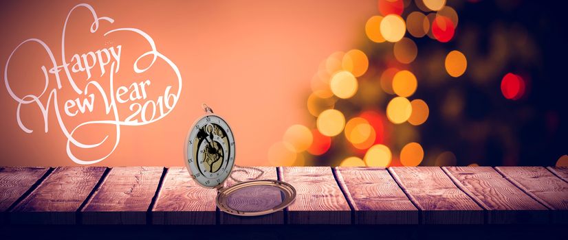 Antique pocket clock with chain against desk with christmas tree in background