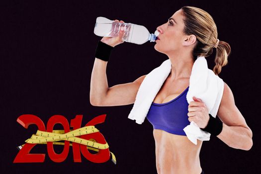 Strong blonde drinking from water bottle against grey background