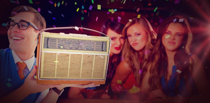 Geeky hipster listening to retro radio against pretty friends drinking cocktails together