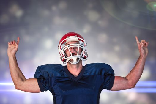 Rugby player celebrating while pointing up against black abstract light spot design