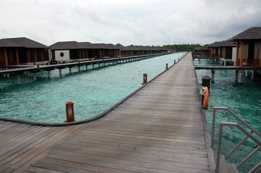 Timber pier and bungalow at Paradise Island Resort Maldives