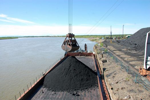 Dockside cargo crane at river port, Kolyma, Russia outback