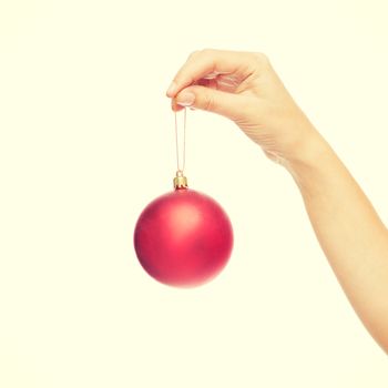 christmas, decoration, holidays and people concept - close up of woman hand holding christmas ball