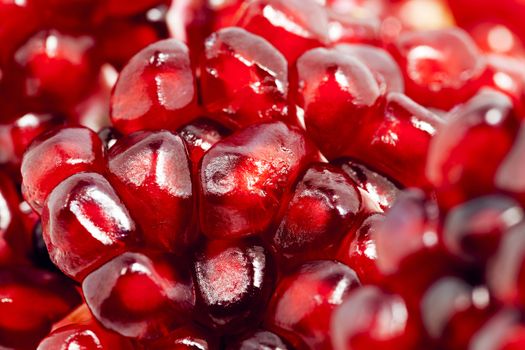  a ripe red pomegranate photographed close up. grain