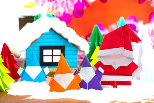 Santa claus family on snow field, small house and christmas tree background