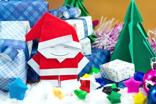 Santa claus and gift box with small star paper on the snow field.