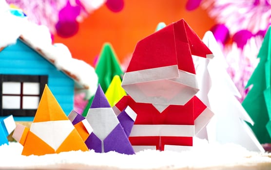 Santa claus family on snow field, small house and christmas tree background