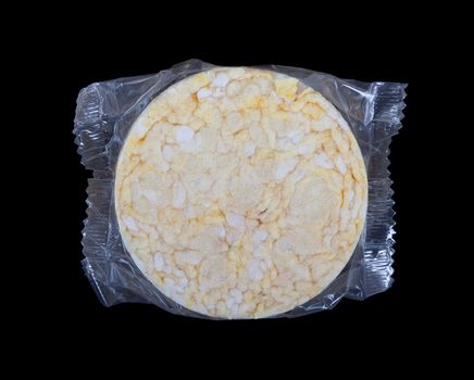 Rice cracker in plastic, isolated on black