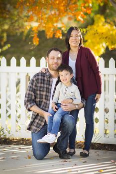 Happy Attractive Mixed Race Young Family Portrait Outdoors.