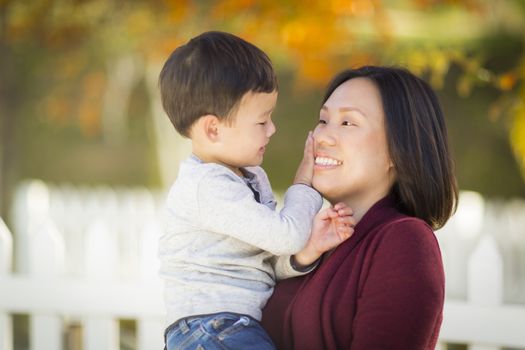 Happy Chinese Mom Having Fun and Holding Her Mixed Race Little Boy.