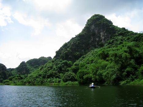 NINH BINH, VIETNAM, JULY, 20: Unidentified tourists in Trang An  on JULY, 20, 2013. Trang An is the scenic area, ranked special of Vietnam.
