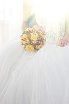 Beautiful wedding bouquet in hands of the bride