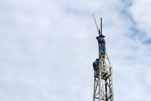 KHANH HOA, VIETNAM, September, 17: Workers fixing wind propeller on September, 17, 2013 in Khanh Hoa, Vietnam