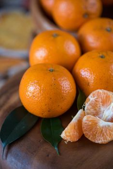 Ripe tangerines on wooden background