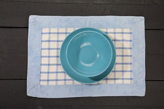 Empty plates on dark black wooden background