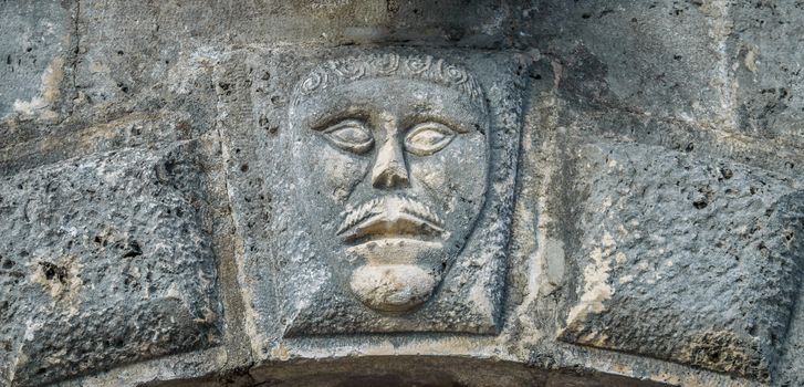 Bas-relief with man's face on musium in Perast 