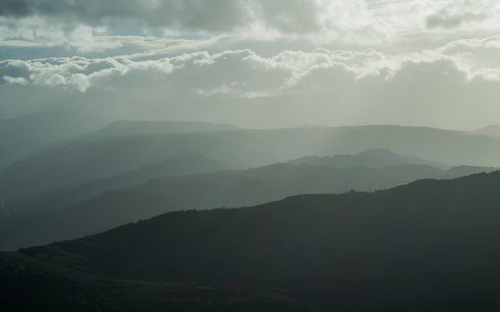 mountains silhouette with fog, natural daily light tint 