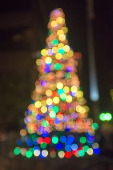 defocused christmas tree lights in a city background