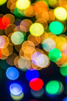 defocused christmas tree lights in a city background