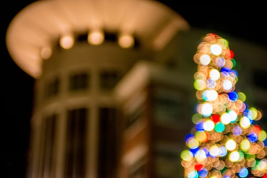 defocused christmas tree lights in a city background