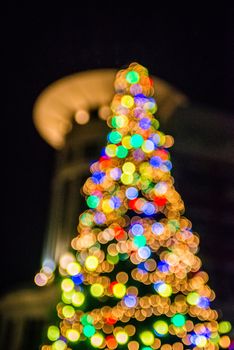 defocused christmas tree lights in a city background