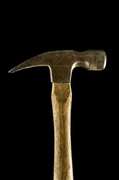 Isolated profile view of a hammer against a black background