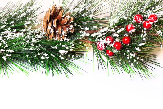 Pine branches with Christmas ornaments on white