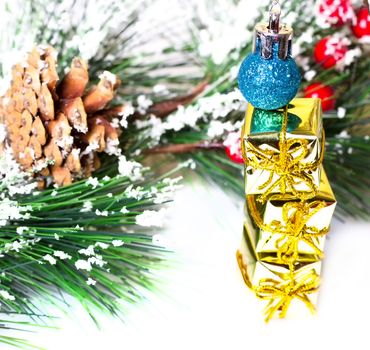 Pine branches with Christmas ornaments on white