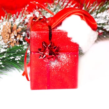 Little handmade gift box with Santa hat in a snow covered 