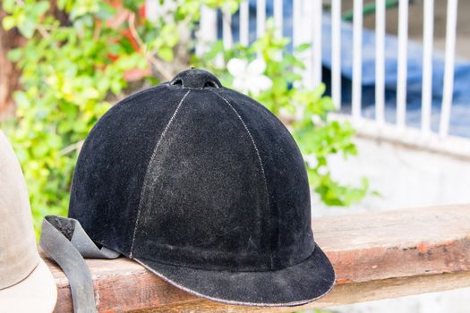 Helmet jockey is on a wooden stand near the site for training