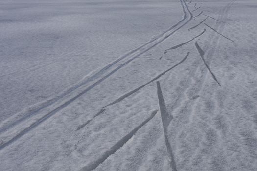 Footprints in the snow of a frozen lake, ski.