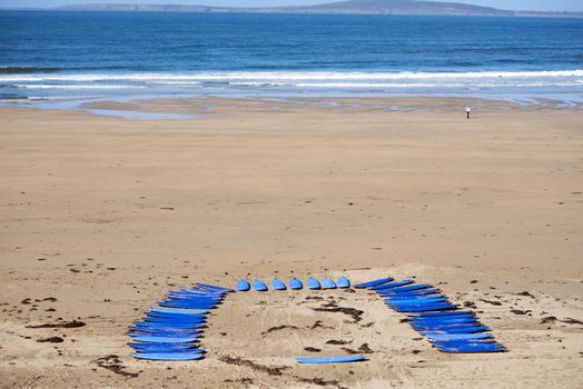 surf boards on the beach in ballybunion ready for a surf schools lessons