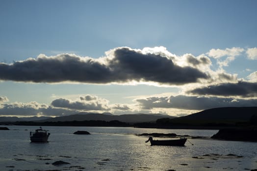 boats in a quiet bay near kenmare on the wild atlantic way ireland at sunset