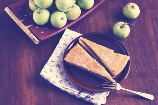 Freshly made apple pie on a table with fresh apples-filter effect retro vintage style
