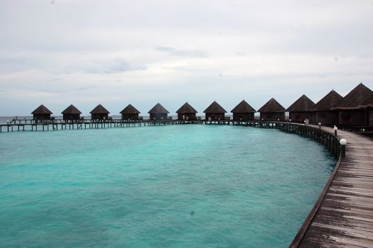 Timber pier and bungalow at Paradise Island Resort Maldives, Indian Ocean