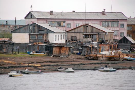 Boats at Kolyma river coast in outback town, Yakutia, Russia