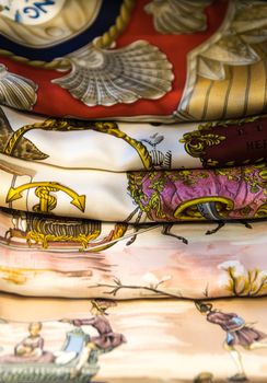 Background consists of five colored silk scarves.