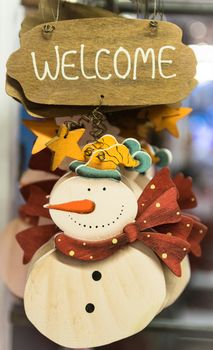 Snowman carved in wood to hang at home.